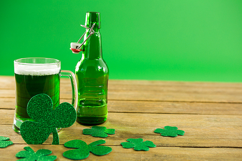 St Patricks Day green beer with shamrock on wooden surface