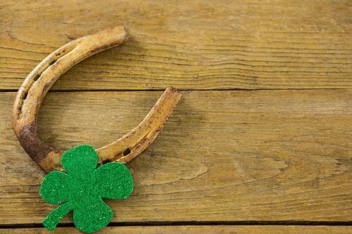 St Patricks Day shamrock with horseshoe on wooden surface