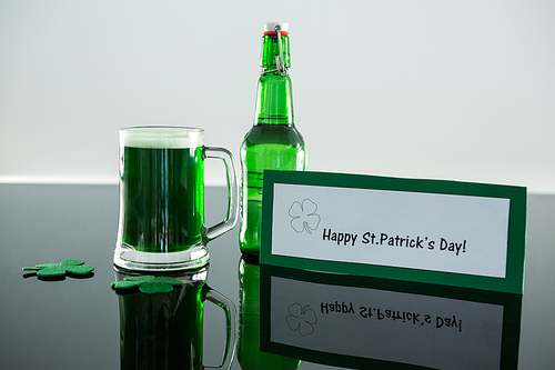 Green beer with shamrock and placard of St Patricks Day on table
