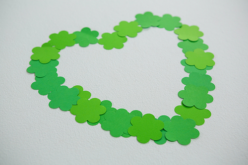 St Patricks Day shamrocks forming heart shape on white background