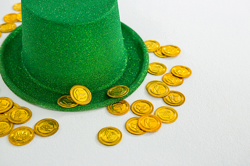 St. Patricks Day leprechaun hat and chocolate gold coins on white background