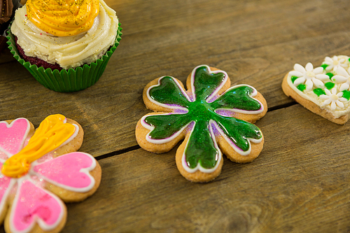 St Patricks Day cupcake and cookies on wooden table