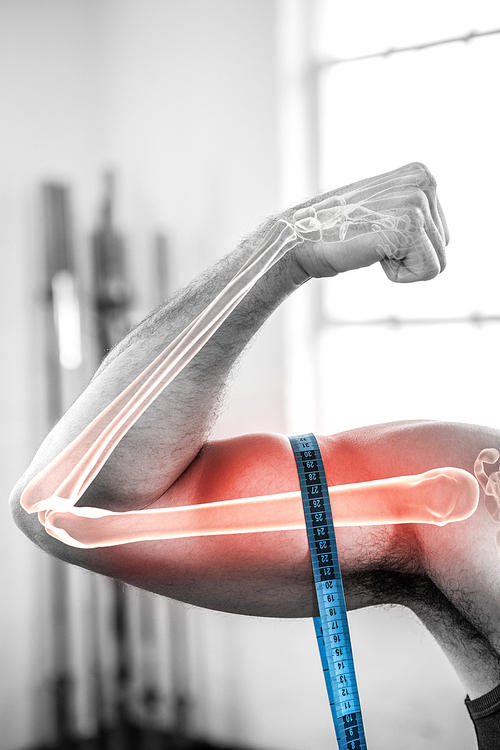 Digital composite of highlighted arm of man measuring biceps with measuring tape