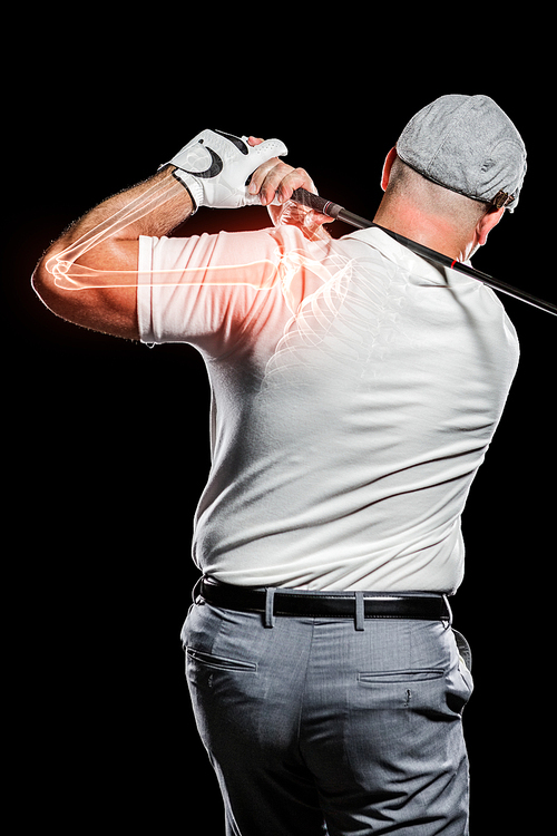 Digitally composite image of golfer playing against black background