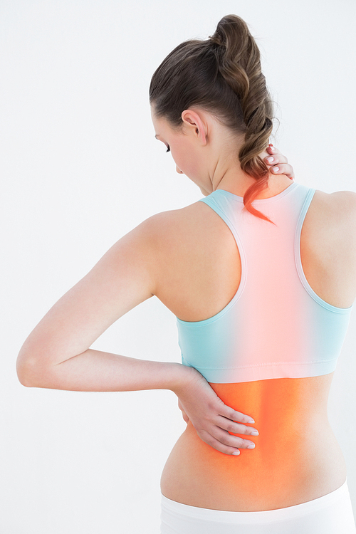 Rear view of woman suffering from back pain against white background