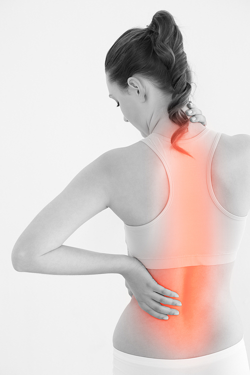 Rear view of female suffering from back pain against white background