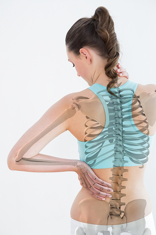 Rear view of female suffering from muscle pain against white background