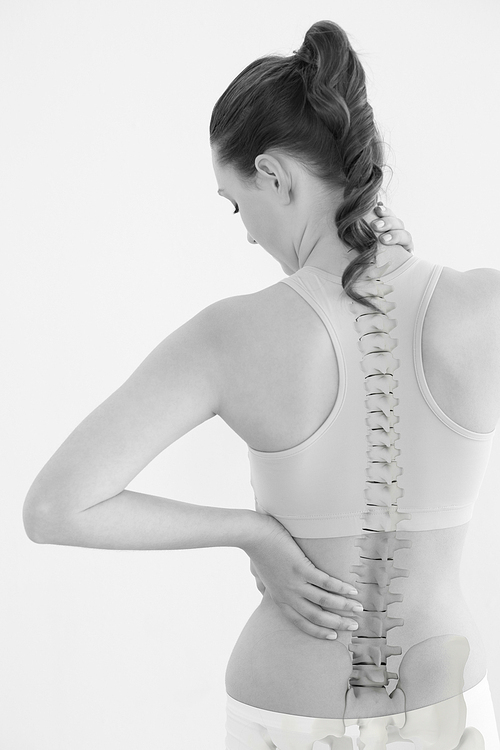 Rear view of female suffering from neck pain against white background