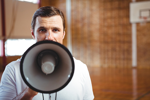 Close up portrait of male coach using megaphone