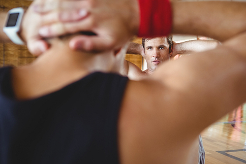 Close up of male friends exercising  with hands behind head