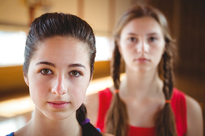 Close up of portrait female basketball player with friend in background