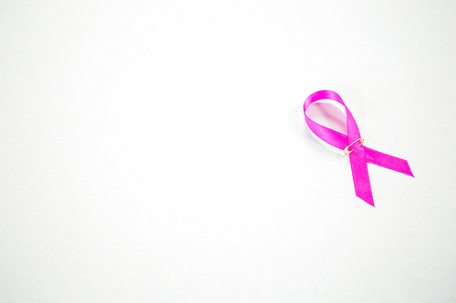 High angle view of pink Breast Cancer Awareness ribbon on white background