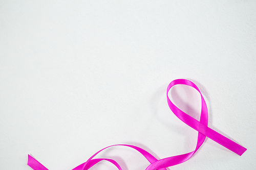 Directly above view of pink Breast Cancer Awareness ribbon on white background