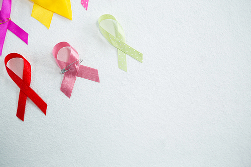 High angle view of various awareness ribbons on white background