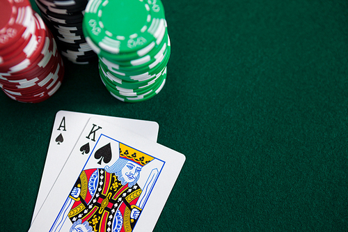 Playing cards and casino chips on poker table in casino