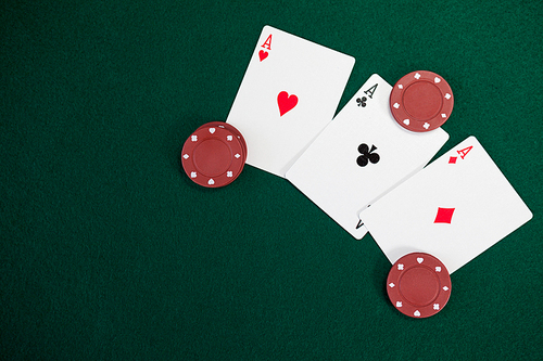 Playing cards and casino chips on poker table in casino