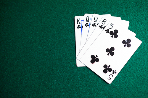 Playing cards arranged on poker table in casino