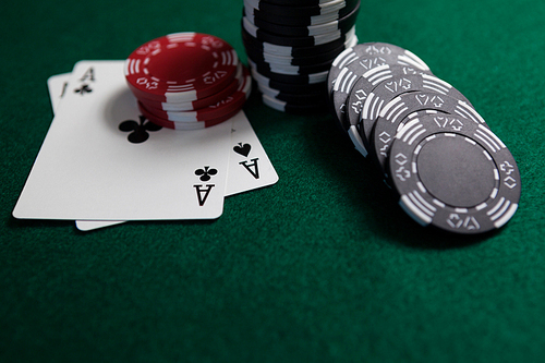 Playing cards and casino chips on poker table in casino