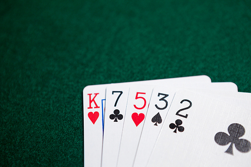 Playing cards arranged on poker table in casino