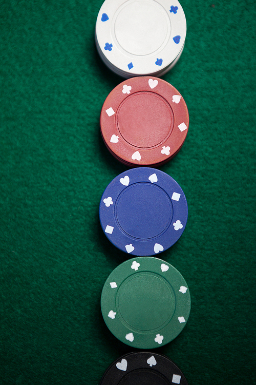 Close-up of casino chips arranged on poker table