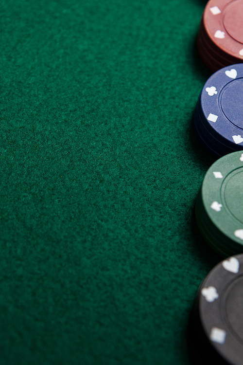 Close-up of casino chips arranged on poker table