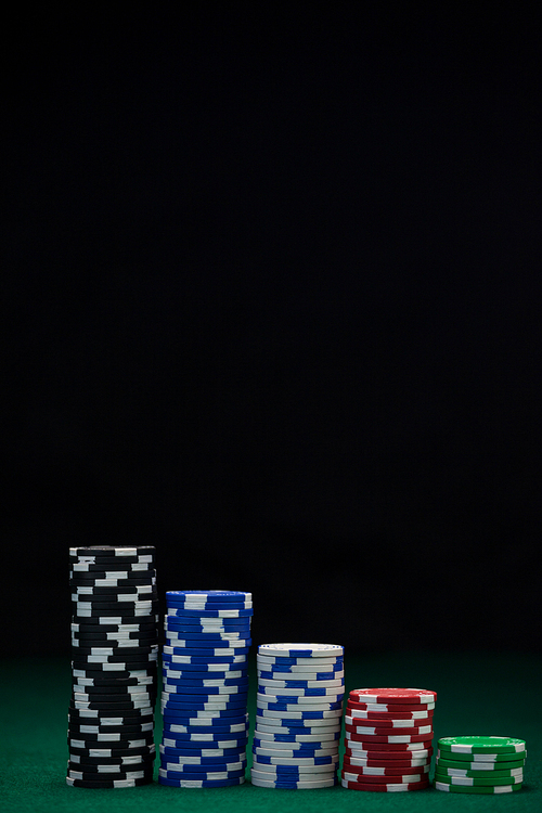 Stacked casino chips arranged on poker table