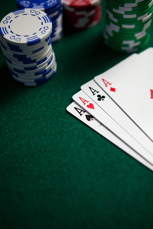 Playing cards and casino chips on poker table in casino