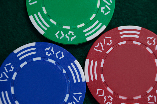 Three casino chips arranged on poker table