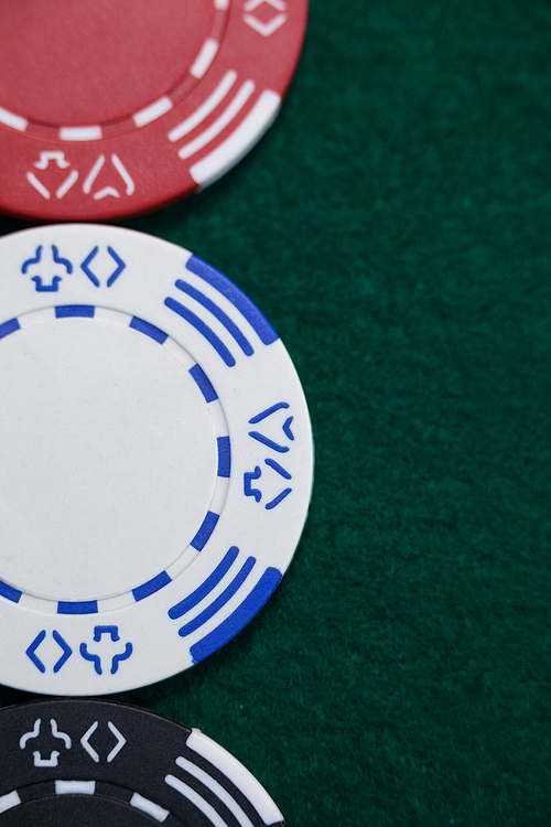 Close-up of casino chips arranged on poker table