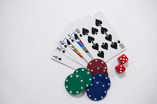 Playing cards, dice and casino chips arranged on white background