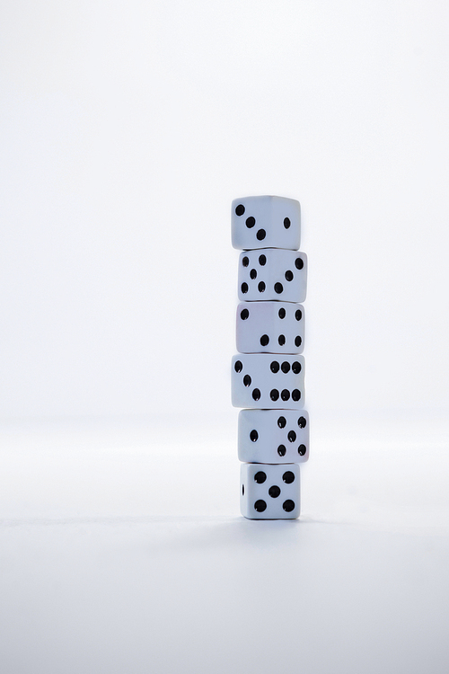 Stack of dices arranged on white background