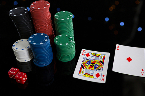 High angle view of cards and chips with dices on table