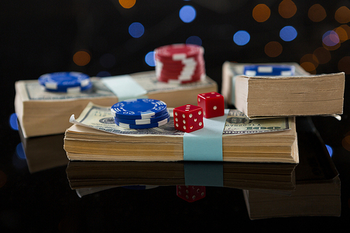 Close-up of chips on paper money at casino table