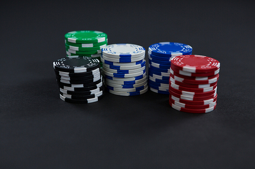 Close-up of chips on black table at casino