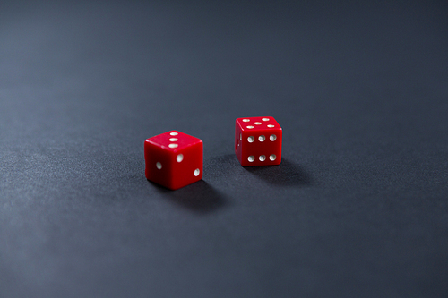 Close-up of red dices on black background