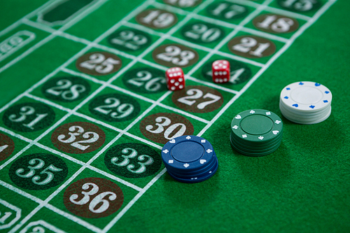 High angle view of dices and chips on roulette table