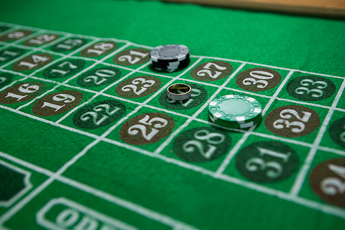 High angle view of ring and chips on roulette table at casino