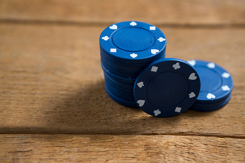 Close-up of blue chips on wooden table