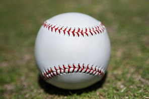 Close-up of baseball on grassy field