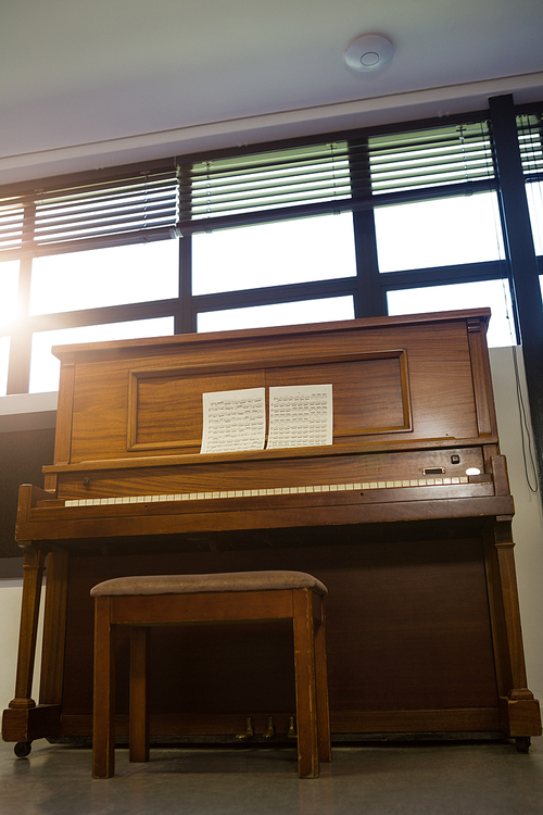 Low angle view of piano against window at home