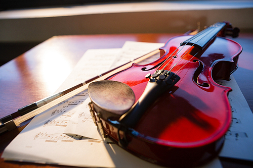 Close up of violin with sheet music on table at classroom