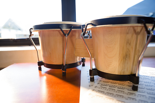 Close up of drums on table against window at classroom