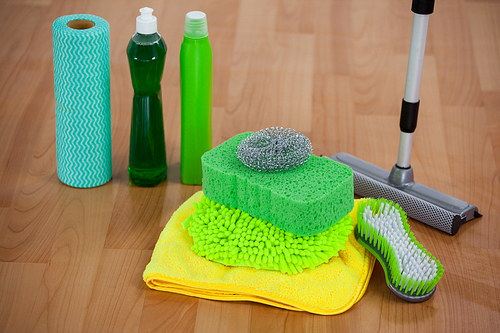 Close-up of various housekeeping supplies on wooden floor