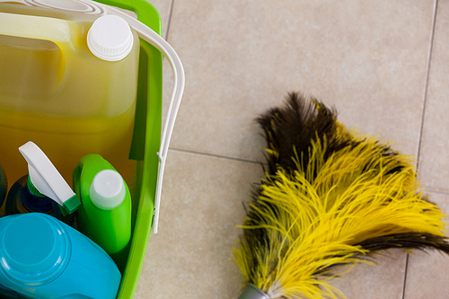 Close-up of bucket with cleaning supplies and mop on tile floor