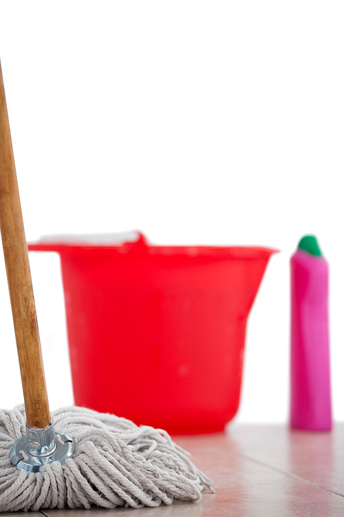 Close-up of mop cleaning the tile floor