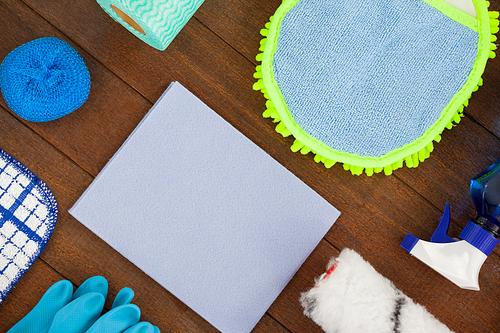 Close-up of various cleaning equipment arranged on wooden floor