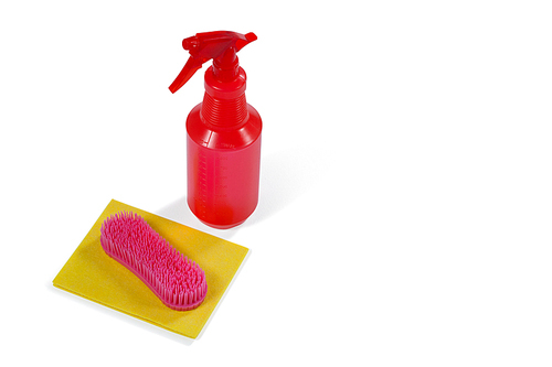 Cleaning spray bottle, sponge and brush on white background