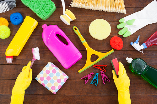 Close-up of various cleaning equipment arranged on wooden floor