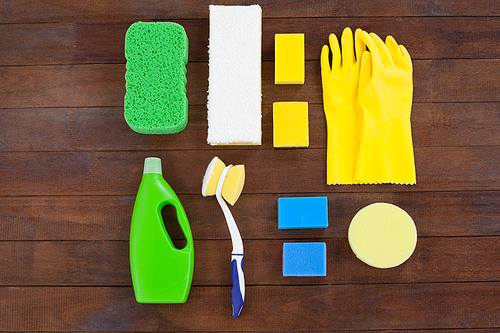 Set of cleaning equipment arranged on wooden floor