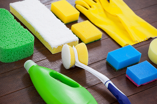 Set of cleaning equipment arranged on wooden floor